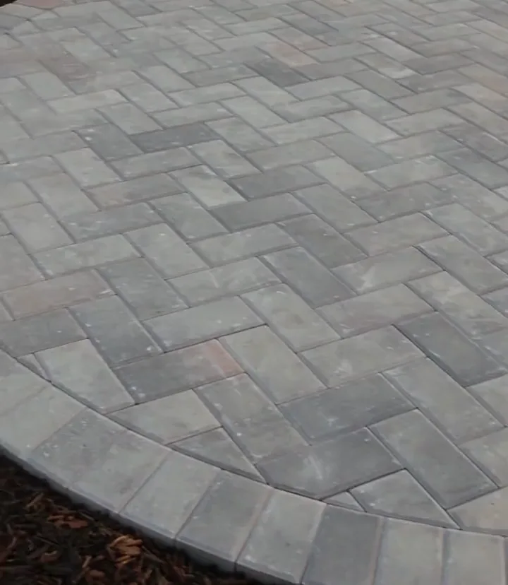 Finished herringbone paver patio with a circle-kit centerpiece